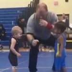 Two Little Wrestlers Give Spectators a Good Laugh as They Take the Mat for the First Time